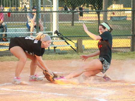 Jenny Rohl/The News Freshman Jordyn Thornell slides into home as junior Emily McFerron catches the ball on base.