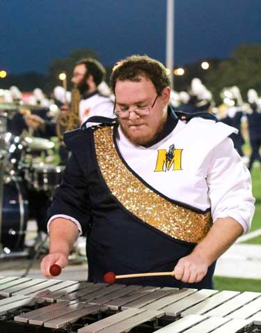 Jenny Rohl/The News Xylophone player, Jacob Therin, concentrates on Fannin’s direction during the halftime performance.