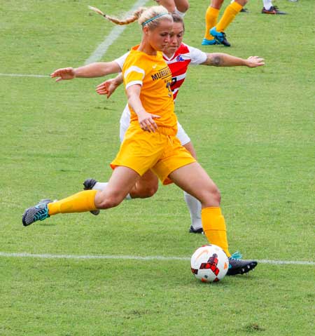 McKenna Dosier/The News Caroline Ashton, freshman forward and midfielder attempts to kick the ball past mid field during the Racers Sept. 11 game against Louisiana Tech.