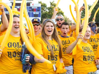 Nicole Ely/The News Freshman rally before the football game Thursday to rush the field for the second annual Gold Rush event hosted by Racer Athletics.