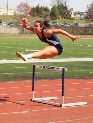 Nicole Ely/The News Taylor McCammon, sophomore hurdler and jumper hurdles in practice. 