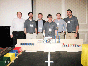 Photo courtesy of Alec Leedy The award-winning team of Racers standing in front of their winning design after a second place victory last week at the SoutheastCon.