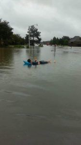 Photo courtesy of Kacie Fountain. Fountain's brother floats on a raft down their neighborhood street.
