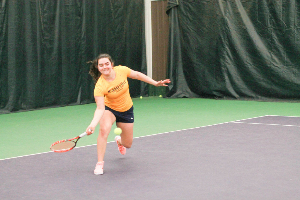 Amina Hadzic, sophomore from Esbjerg, Denmark stretches for a swing at Kenlake courts.
